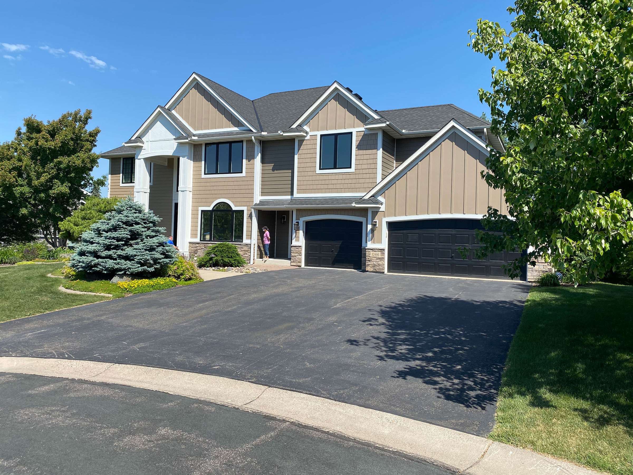 A large multi-family townhome building with attached garages
