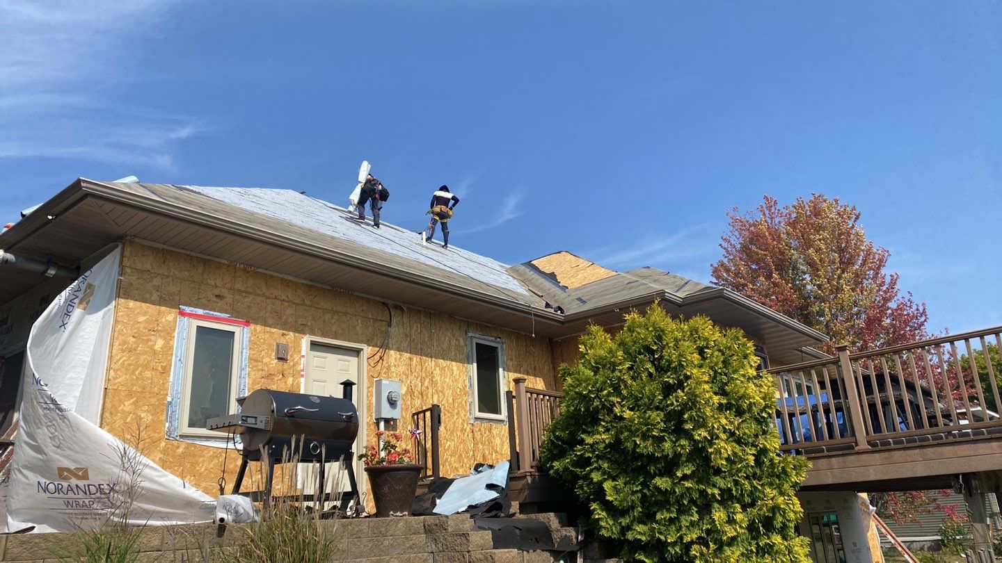 Two Capital City roofers working on a residential rooftop